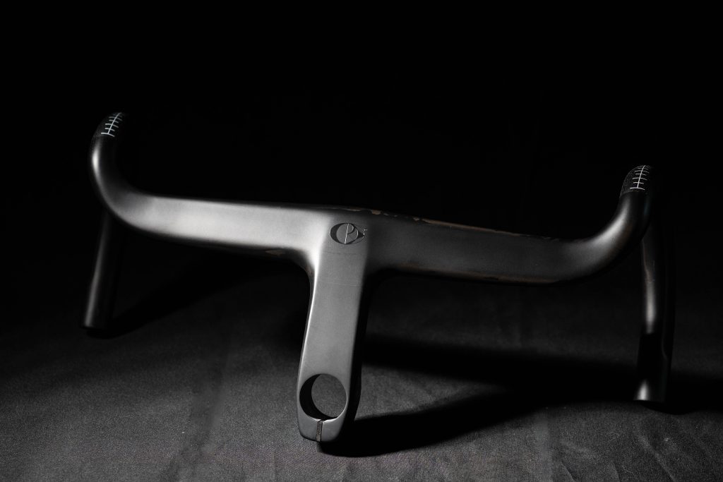 A CRW HB01 handlebar sits on a black surface